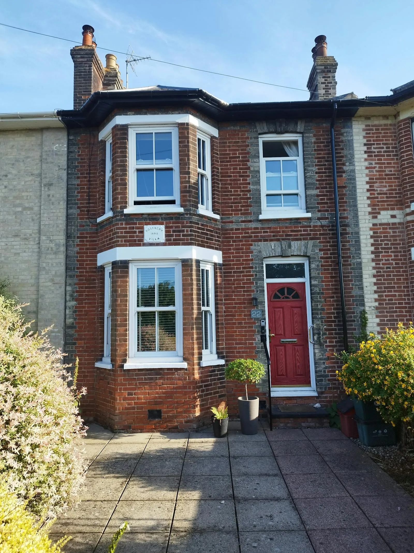 An Edwardian red-brick semi with a white bay window in Bristol — owner-occupied and privately rented homes like this can claim the £7,500 heat pump grant.
