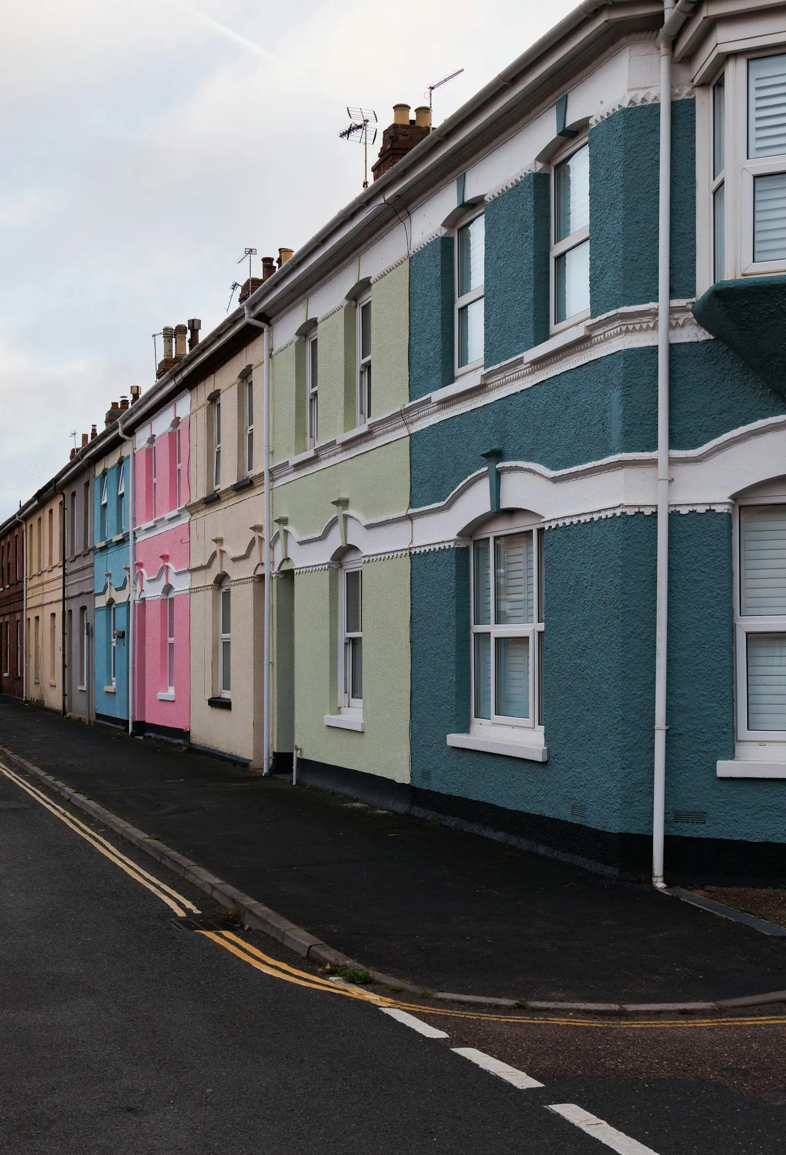 A row of brightly painted Victorian terraces in Bristol — colourful period streets like this can run comfortably on a well-designed heat pump.